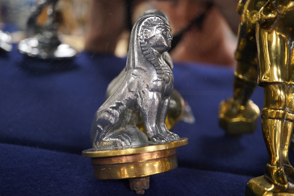 Eight figural chrome and brass car mascots, etc. including a knight in full armour mounted on a threaded radiator cap, a sphinx mounted on a threaded radiator cap, plus an additional sphinx mounted on an alabaster plinth
